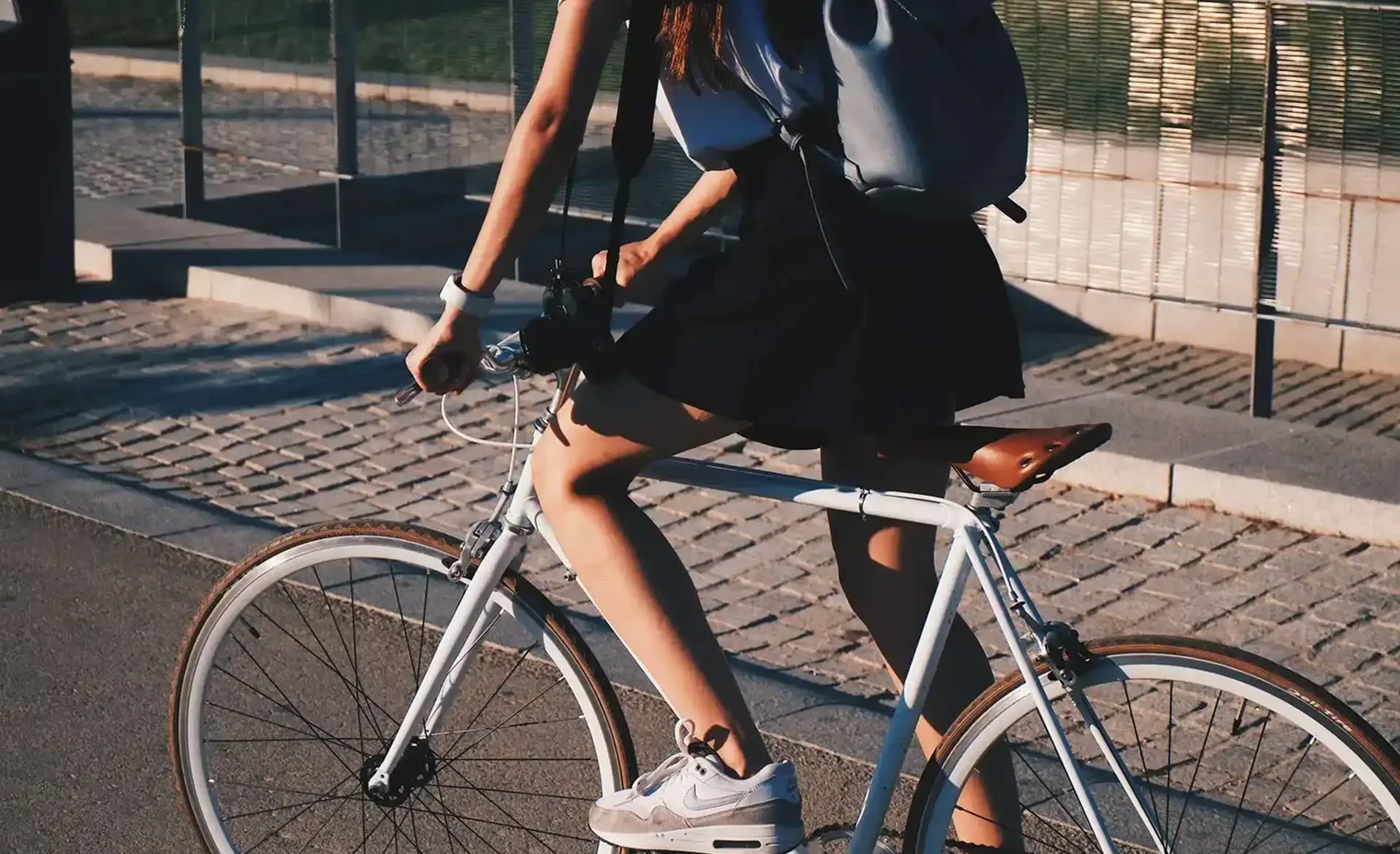 a woman riding a bicycle in a city street.webp
